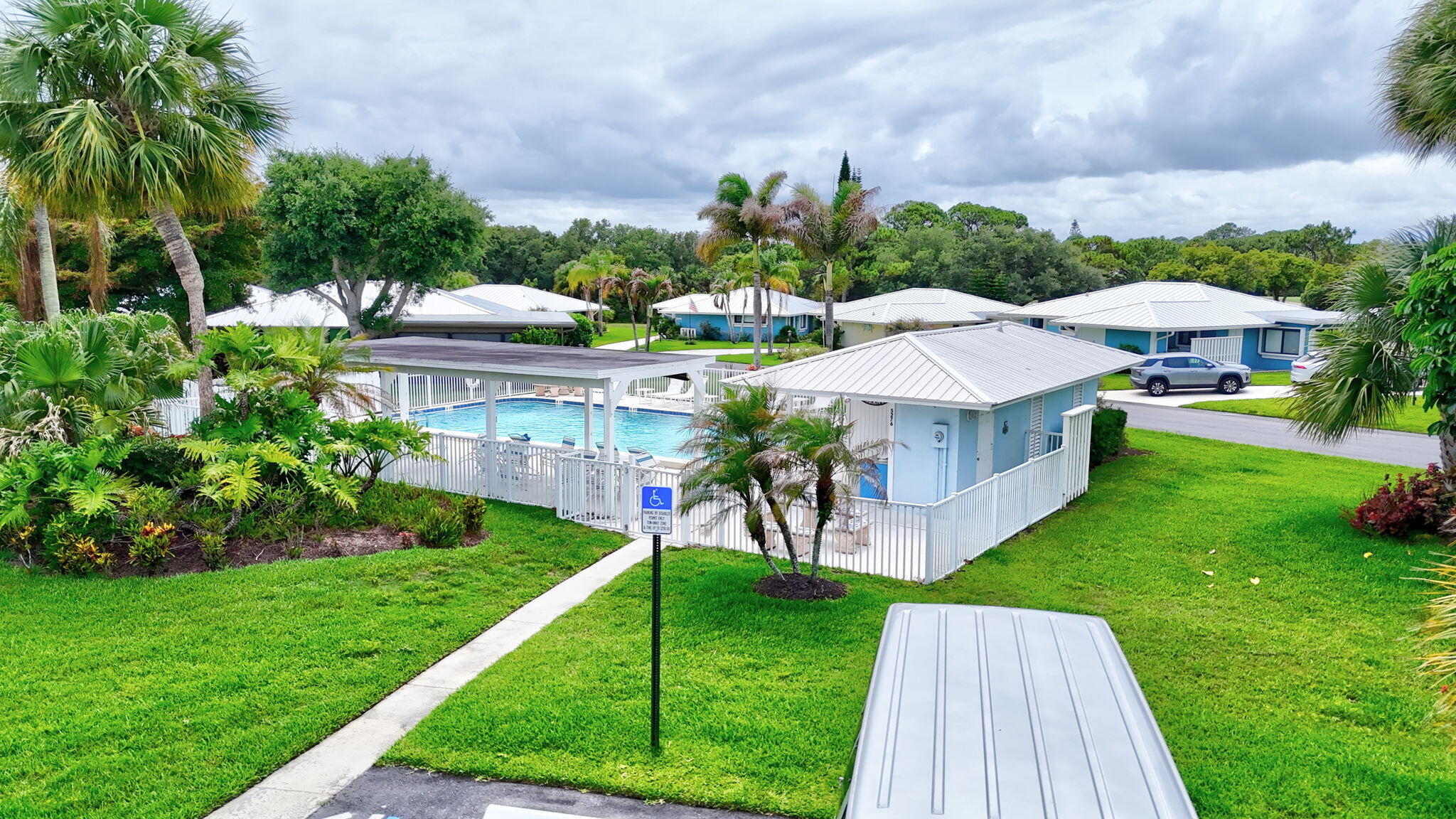 5251 Southeast Sea Island Way Stuart, FL 34997 - Photo 51 of 68 a view of a house with a yard and a garden
