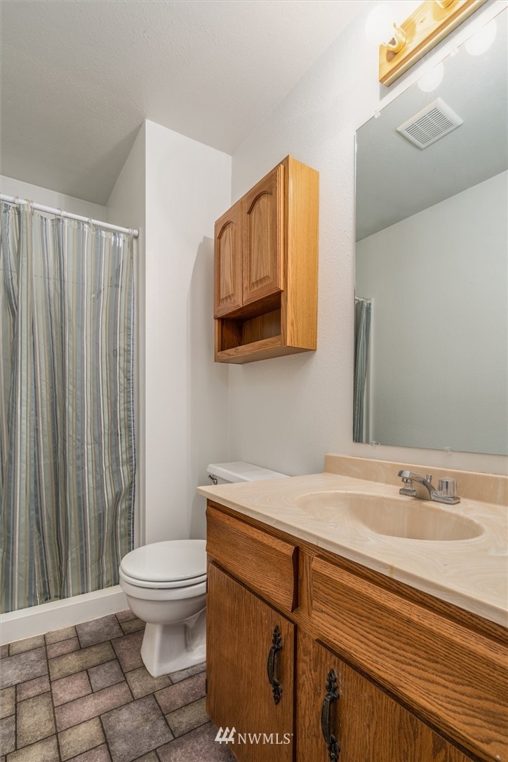 131 Tingle Road Winlock, WA 98596 - Photo 16 of 31 a bathroom with a sink a toilet and mirror