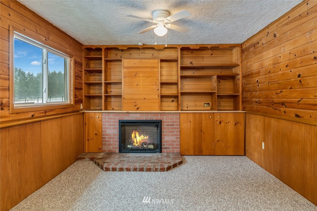 131 Tingle Road Winlock, WA 98596 - Photo 18 of 31 a view of an empty room with a fireplace and a window
