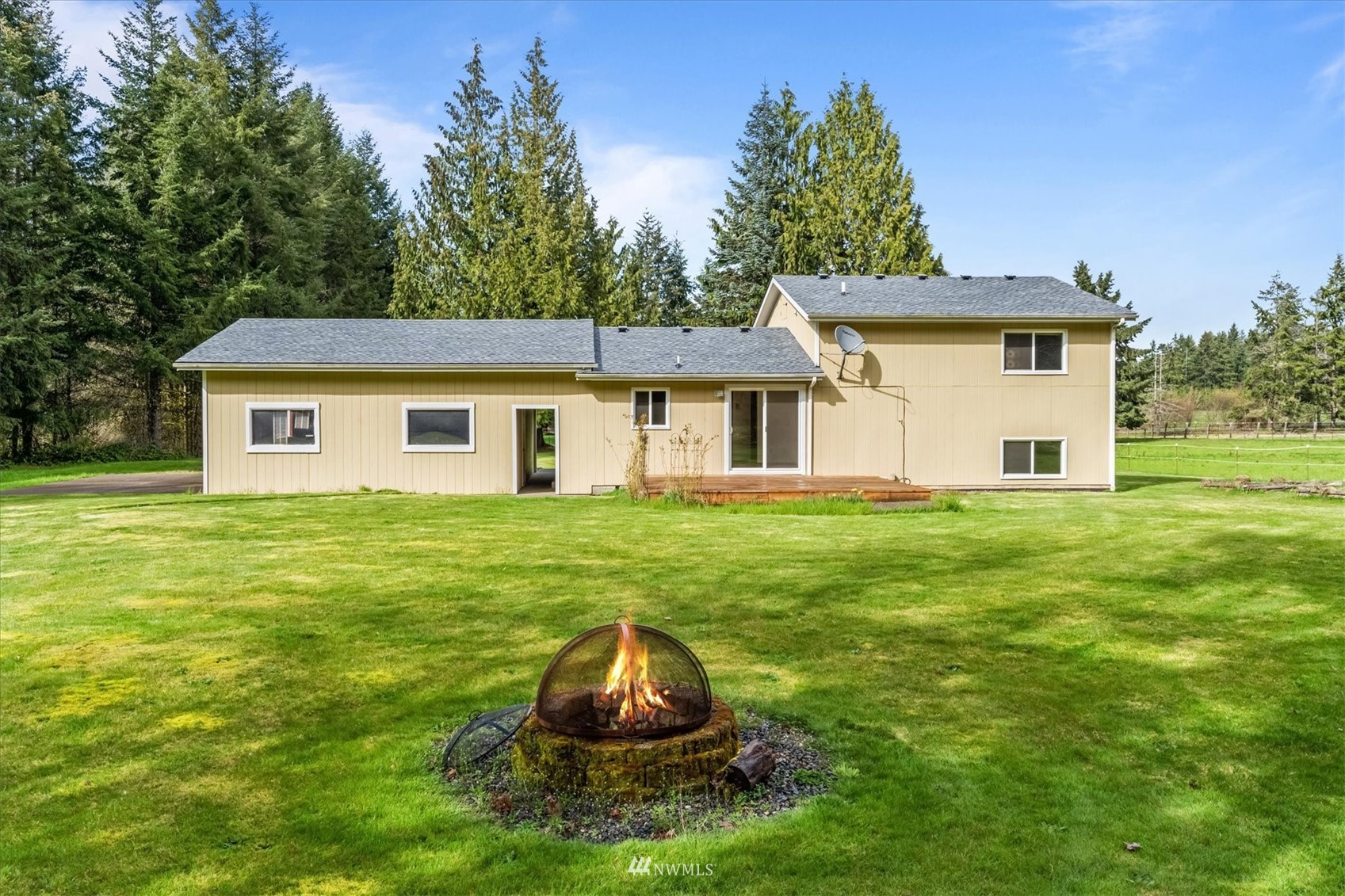 131 Tingle Road Winlock, WA 98596 - Photo 24 of 31 a backyard of a house with a garden and barbeque oven