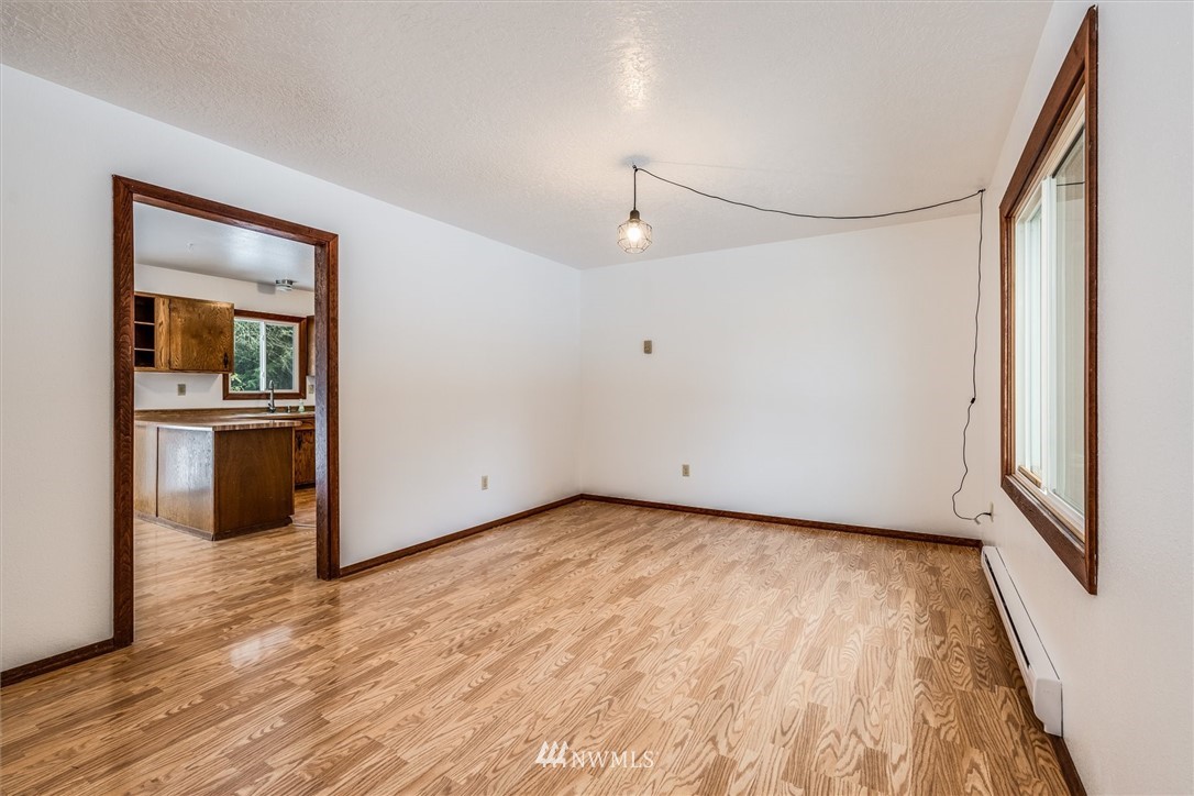 131 Tingle Road Winlock, WA 98596 - Photo 4 of 31 a view of a big room with wooden floor and kitchen