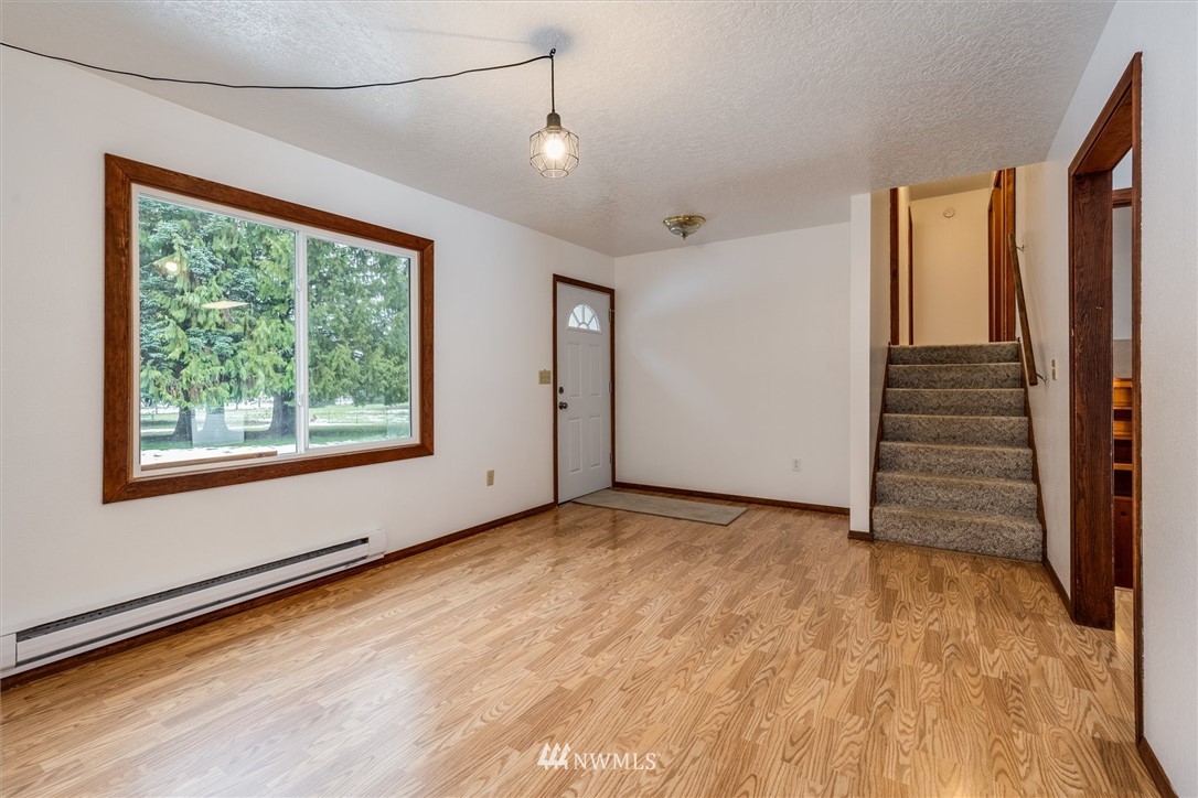 131 Tingle Road Winlock, WA 98596 - Photo 5 of 31 a view of an empty room with a window and wooden floor