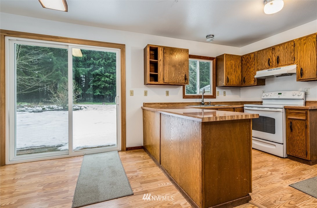 131 Tingle Road Winlock, WA 98596 - Photo 9 of 31 a kitchen with stainless steel appliances granite countertop a stove a sink and a microwave