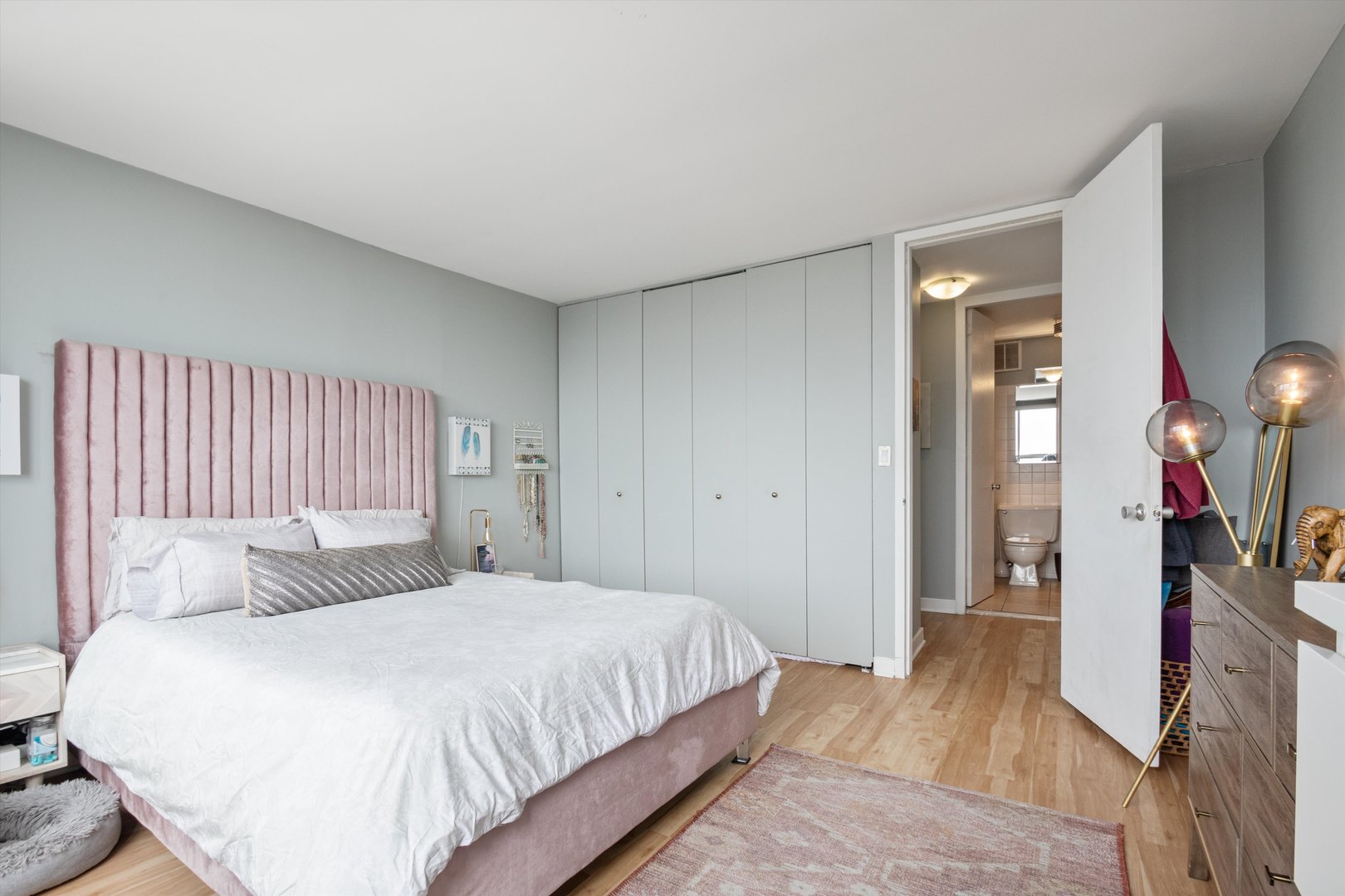655 West Irving Park Road, Unit 3717 Chicago, IL 60613 - Photo 13 of 24 a bedroom with a bed and a mirror