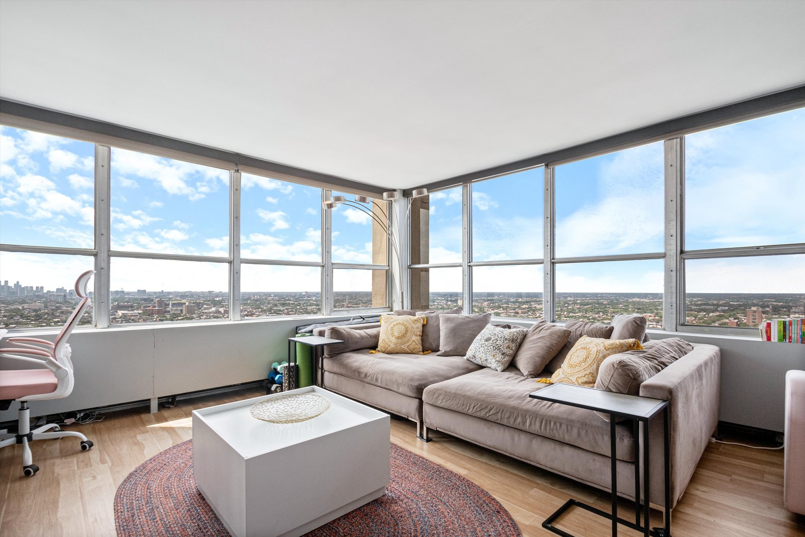 655 West Irving Park Road, Unit 3717 Chicago, IL 60613 - Photo 3 of 24 a living room with furniture and large windows