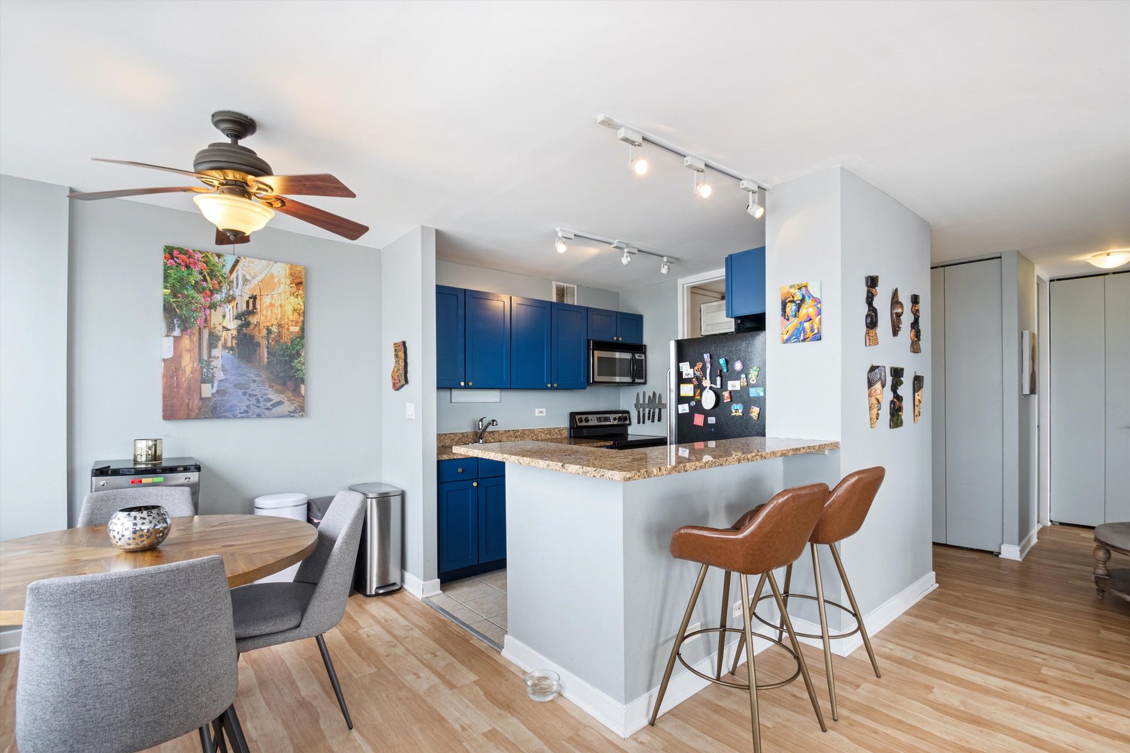 655 West Irving Park Road, Unit 3717 Chicago, IL 60613 - Photo 8 of 24 a kitchen with stainless steel appliances granite countertop a dining table chairs stove and refrigerator