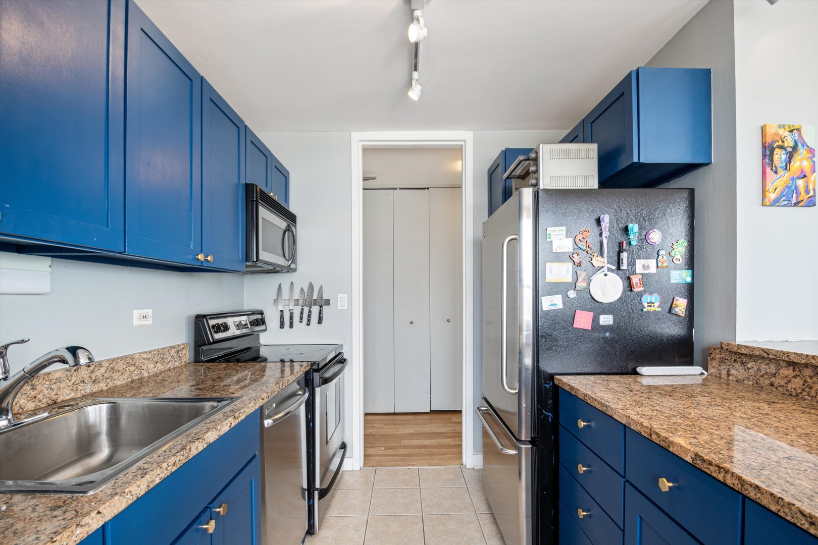 655 West Irving Park Road, Unit 3717 Chicago, IL 60613 - Photo 10 of 24 a kitchen with stainless steel appliances granite countertop a sink stove and refrigerator
