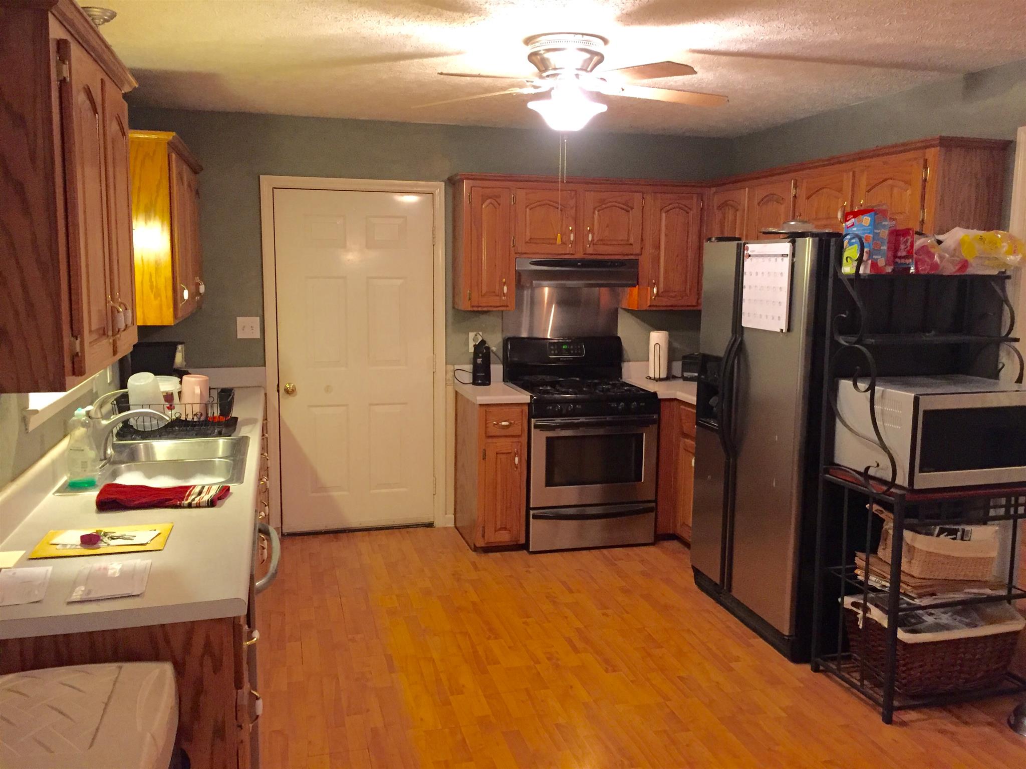 7040 Hoods Branch Road Springfield, TN 37172 - Photo 5 of 10 a kitchen with stainless steel appliances kitchen island granite countertop a refrigerator stove and sink