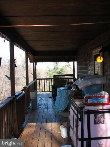 218 Long View Road Linden, VA 22642 - Photo 3 of 16 a balcony with wooden floor table and chairs