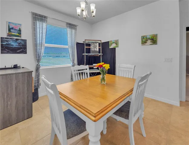 a dining room with furniture and window