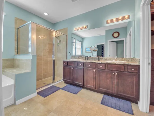 a spacious bathroom with a granite countertop sink mirror and a shower