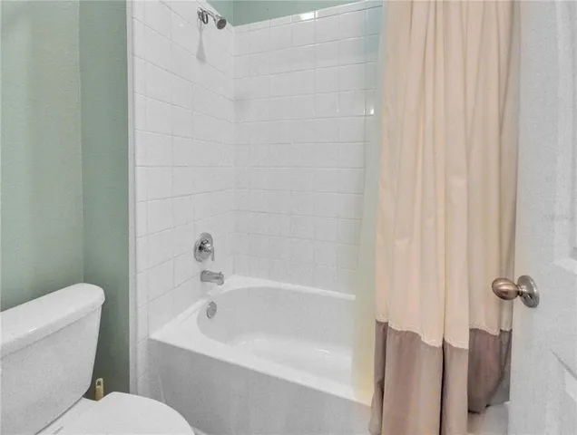 a white bath tub sitting next to a white toilet