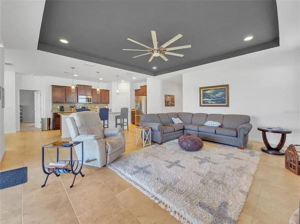 a living room with furniture and kitchen view