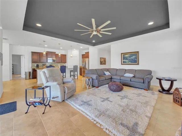 a living room with furniture and kitchen view