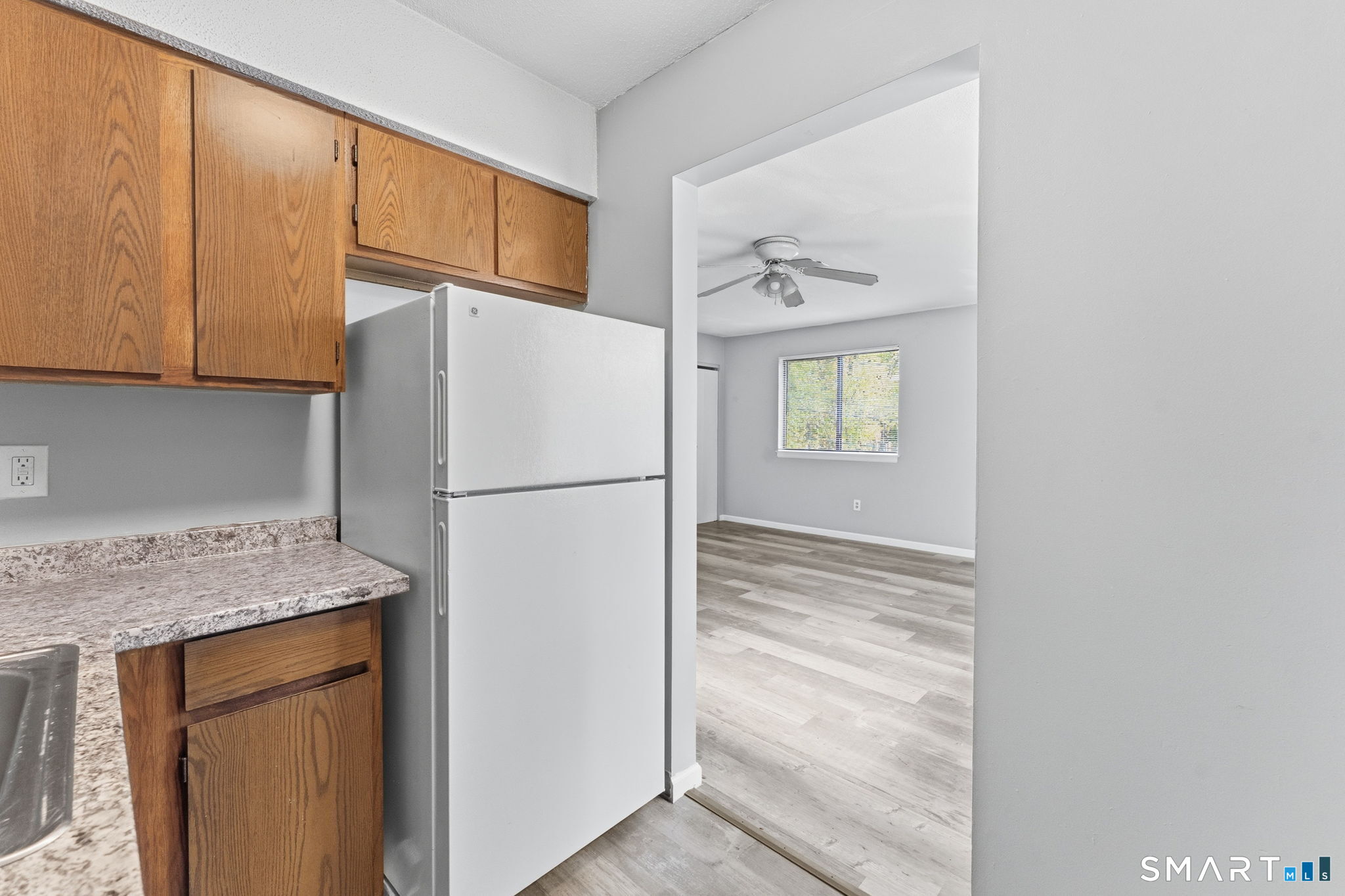 5-7 Warner St Extension, Unit 5B Hartford, CT 06114 - Photo 8 of 17 a white refrigerator freezer sitting in a kitchen