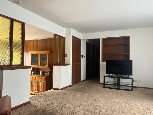 a bedroom with a bed and a desk