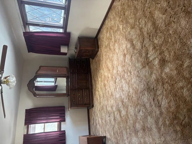 a view of staircase with wooden floor and a window
