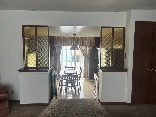 a view of hall way with furniture