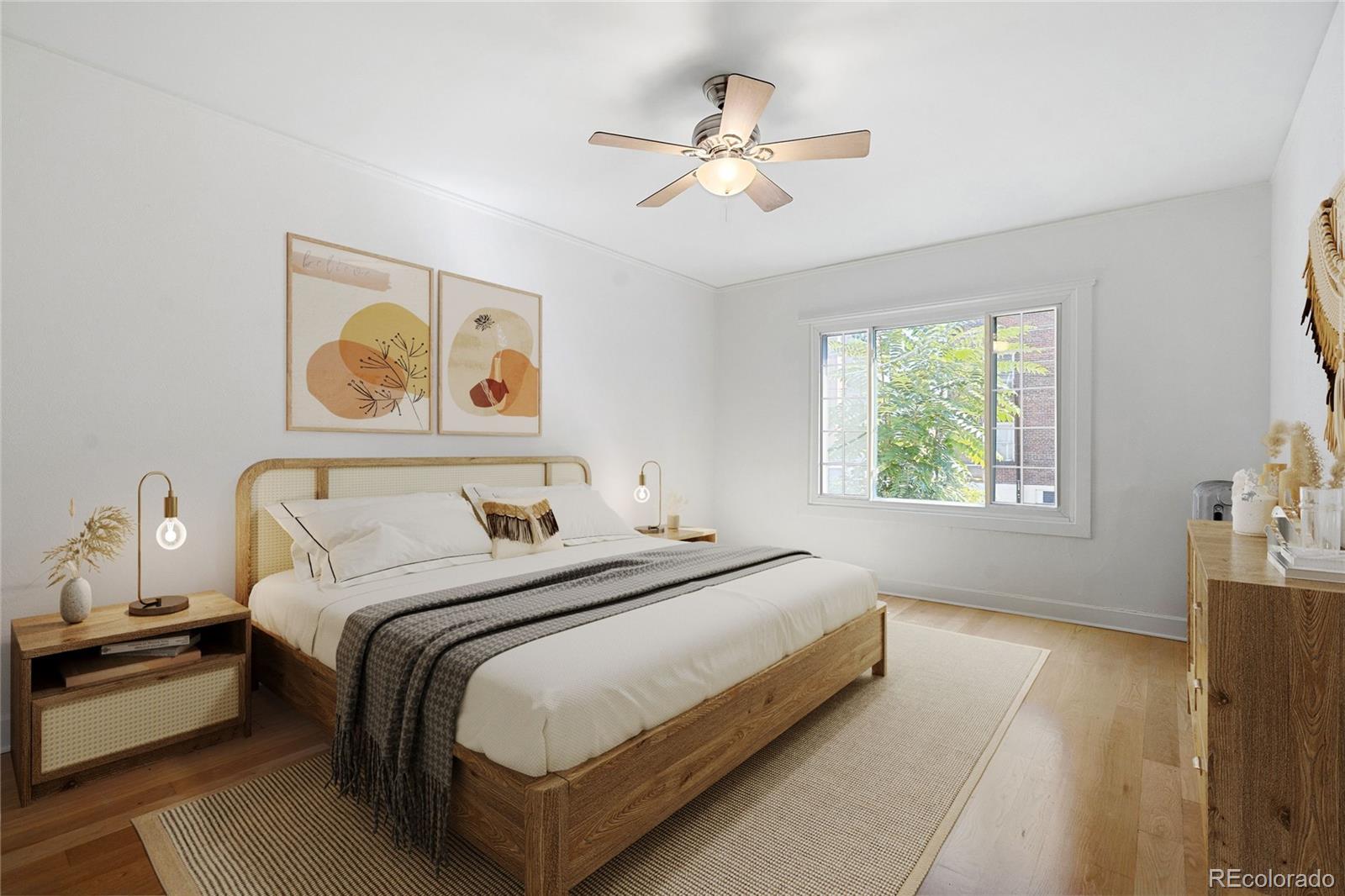 1416 North Downing Street, Unit 2 Denver, CO 80218 - Photo 6 of 12 a bedroom with a bed and a chandelier