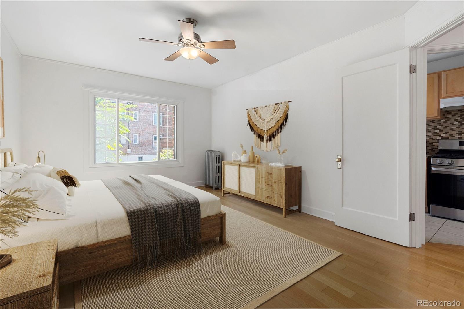 1416 North Downing Street, Unit 2 Denver, CO 80218 - Photo 7 of 12 a bedroom with a bed and a chandelier