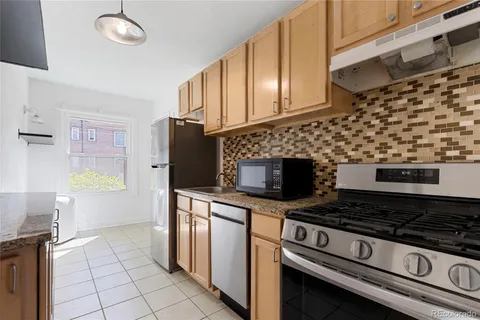 a kitchen with granite countertop a stove and a sink
