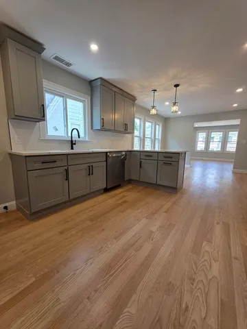 a large kitchen with stainless steel appliances granite countertop a large counter top and sink