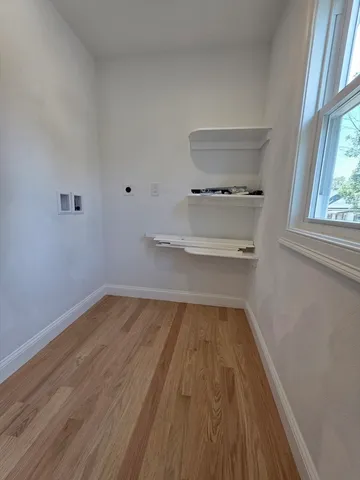 a view of a room with wooden floor