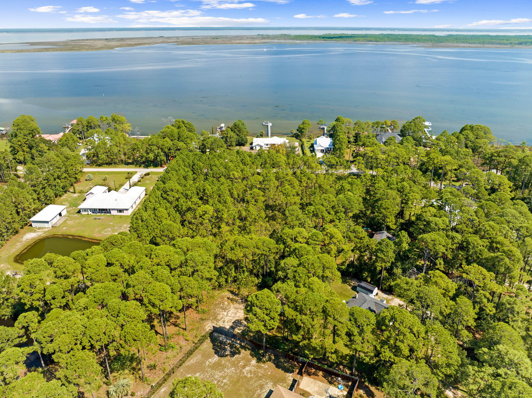 Lot 30 Woodland Bayou Drive Santa Rosa Beach, FL 32459 - Photo 16 of 28 a view of a lake with a building in the background