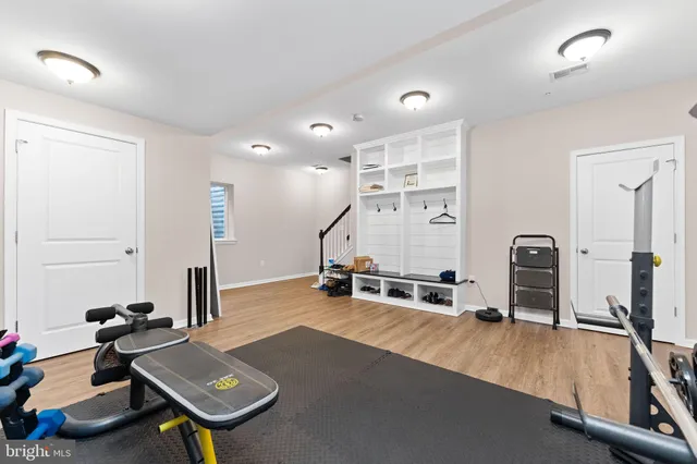 a room with gym equipment and view of living room