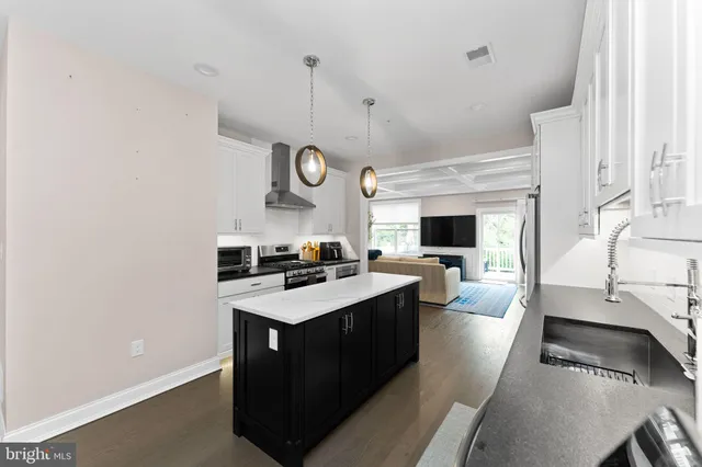 a kitchen with a sink stove and cabinets