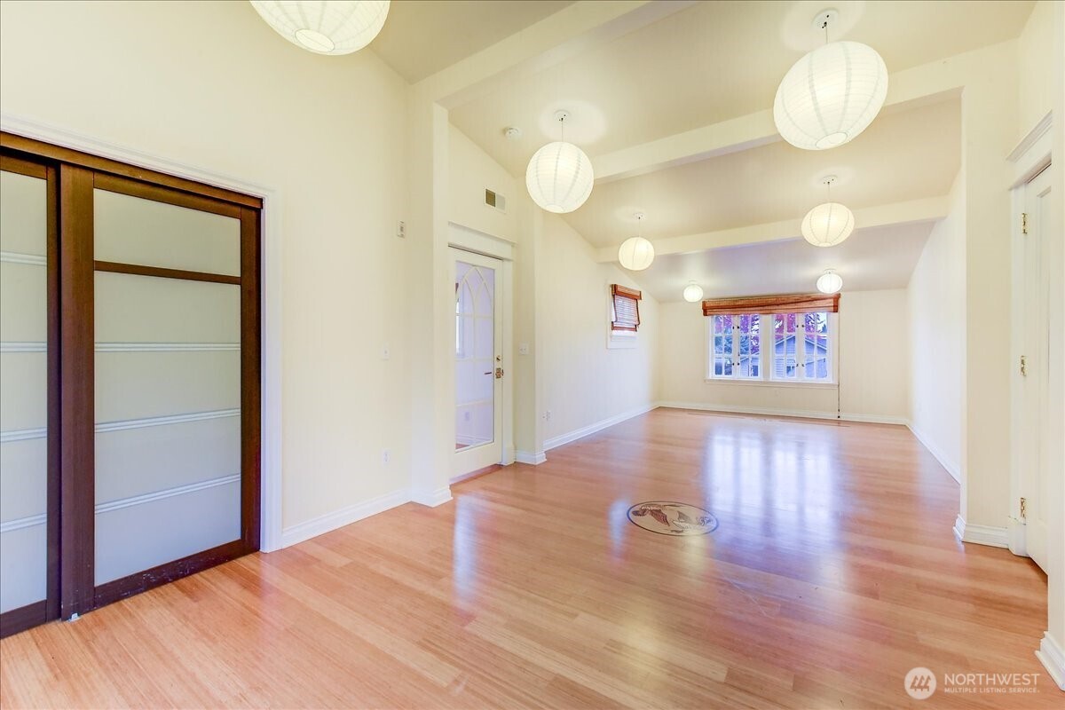 1313 Washington Street Sumner, WA 98390 - Photo 16 of 40 a view of an empty room with window and wooden floor