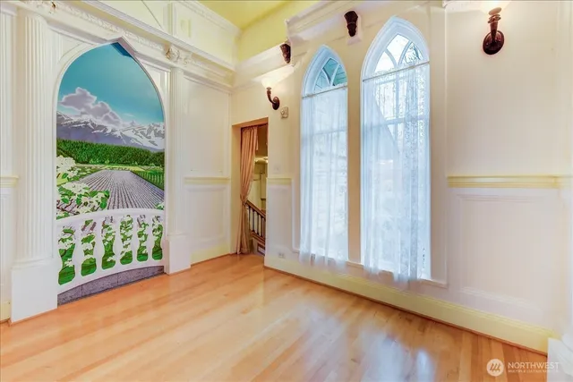 a view of entryway and hall with wooden floor