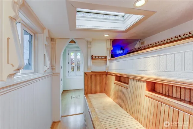 a view of a hallway with wooden floor and staircase