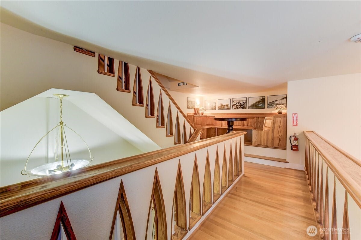 1313 Washington Street Sumner, WA 98390 - Photo 26 of 40 a view of a hallway with wooden floor and staircase