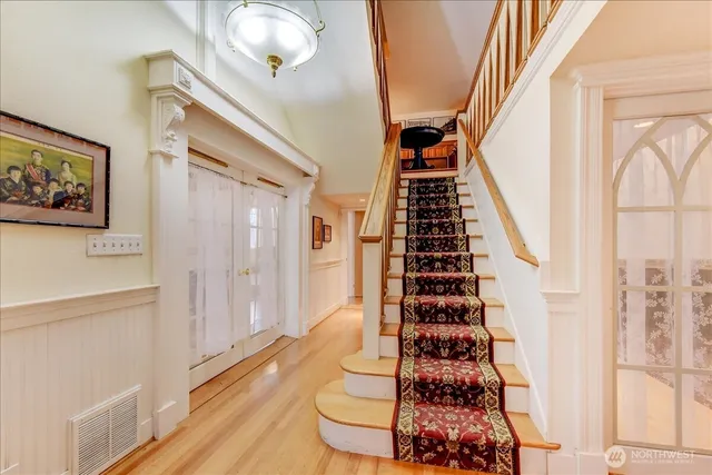 a dining room with furniture and wooden floor