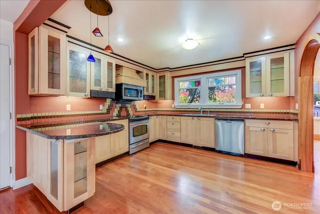a kitchen with stainless steel appliances granite countertop a stove and a sink