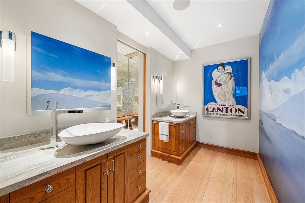 436 Lewis Wharf, Unit 436 Boston, MA 02110 - Photo 23 of 40 a spacious bathroom with a granite countertop sink and a mirror