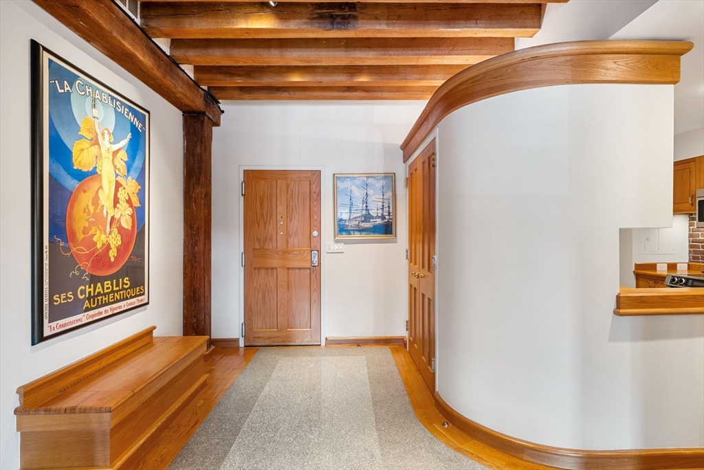 436 Lewis Wharf, Unit 436 Boston, MA 02110 - Photo 7 of 40 a view of a hallway with wooden floor and door