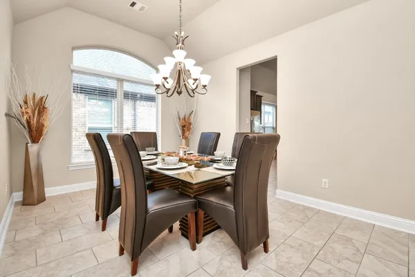 a view of a dining room with furniture and chandelier