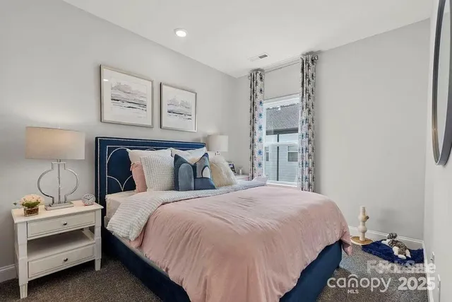 a bathroom with a granite countertop sink a toilet a mirror and shower