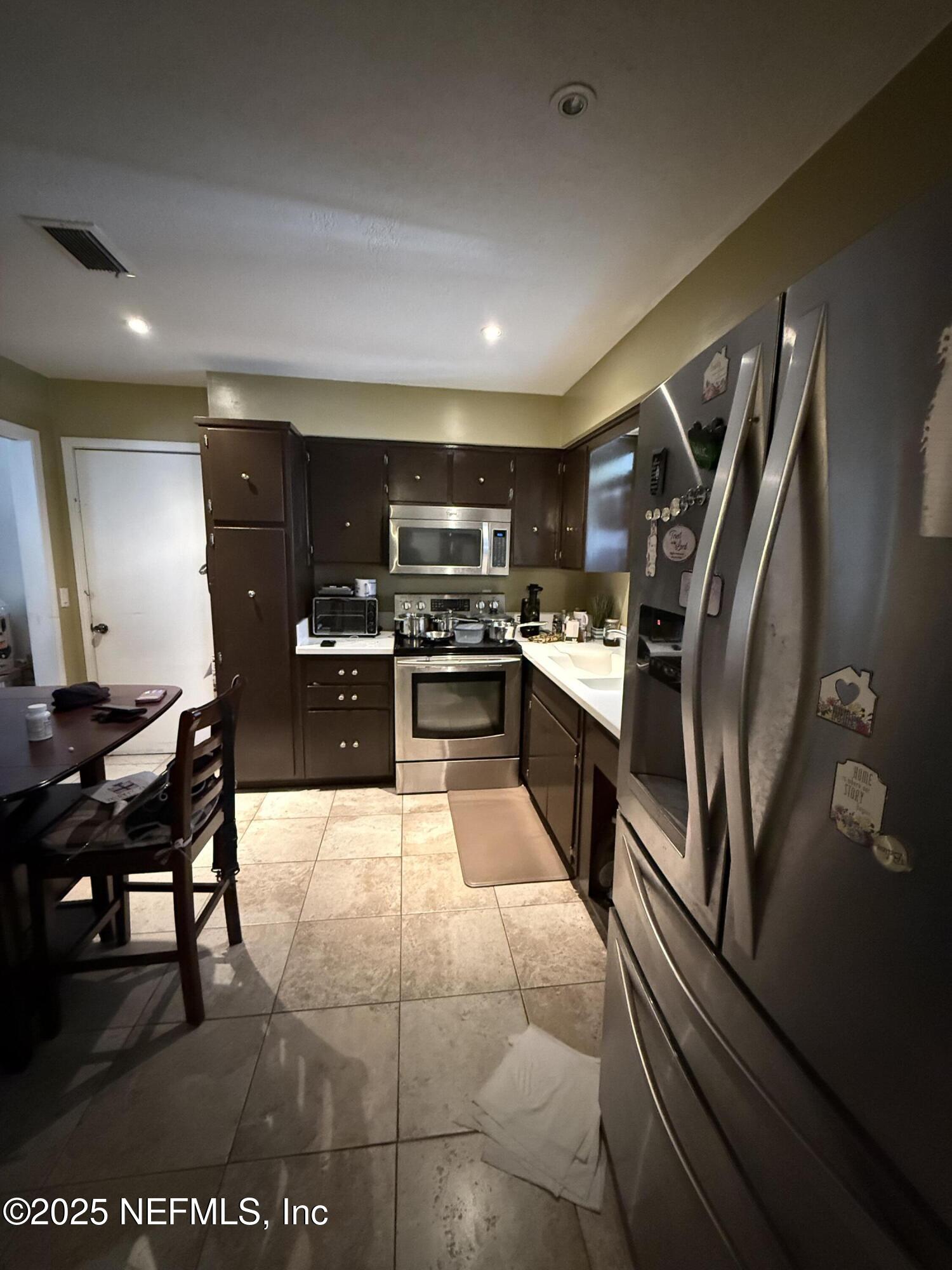 3976 Raintree Road Jacksonville, FL 32277 - Photo 5 of 13 KITCHEN-VIEW FROM FAMILY ROOM
