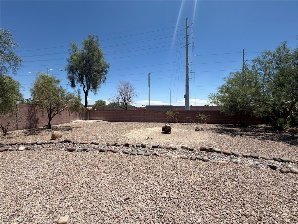6116 Rabbit Track Street Las Vegas, NV 89130 - Photo 26 of 28 A spacious, rock-covered backyard provides a low-maintenance outdoor living area.