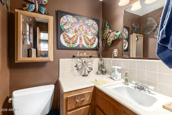 a bathroom with a toilet sink and mirror