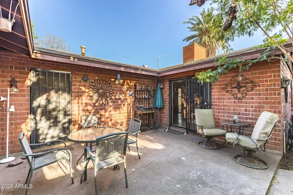 a view of a chairs and table in the patio