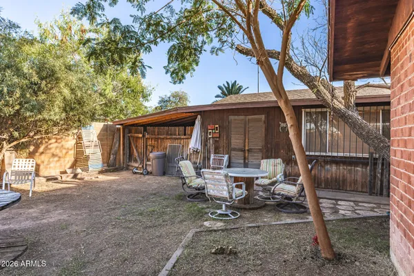 a view of a house with backyard porch and sitting area