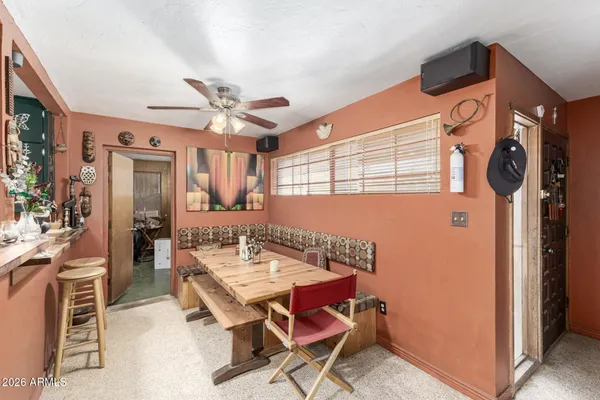a dining room with furniture and a chandelier