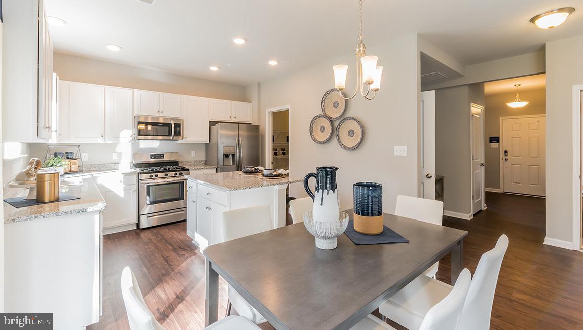 142 Cox Road Barnegat, NJ 08005 - Photo 8 of 25 a kitchen with stainless steel appliances granite countertop a stove a kitchen island a dining table and chairs