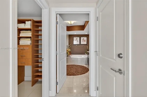 a bathroom with a tub a sink and a large mirror