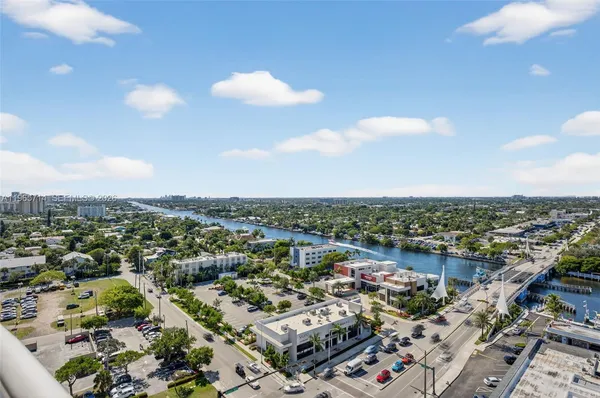 a view of a swimming pool with a patio and a yard