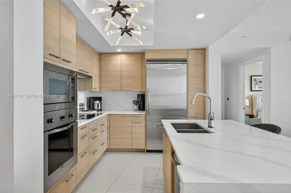 a kitchen with a sink stainless steel appliances and cabinets